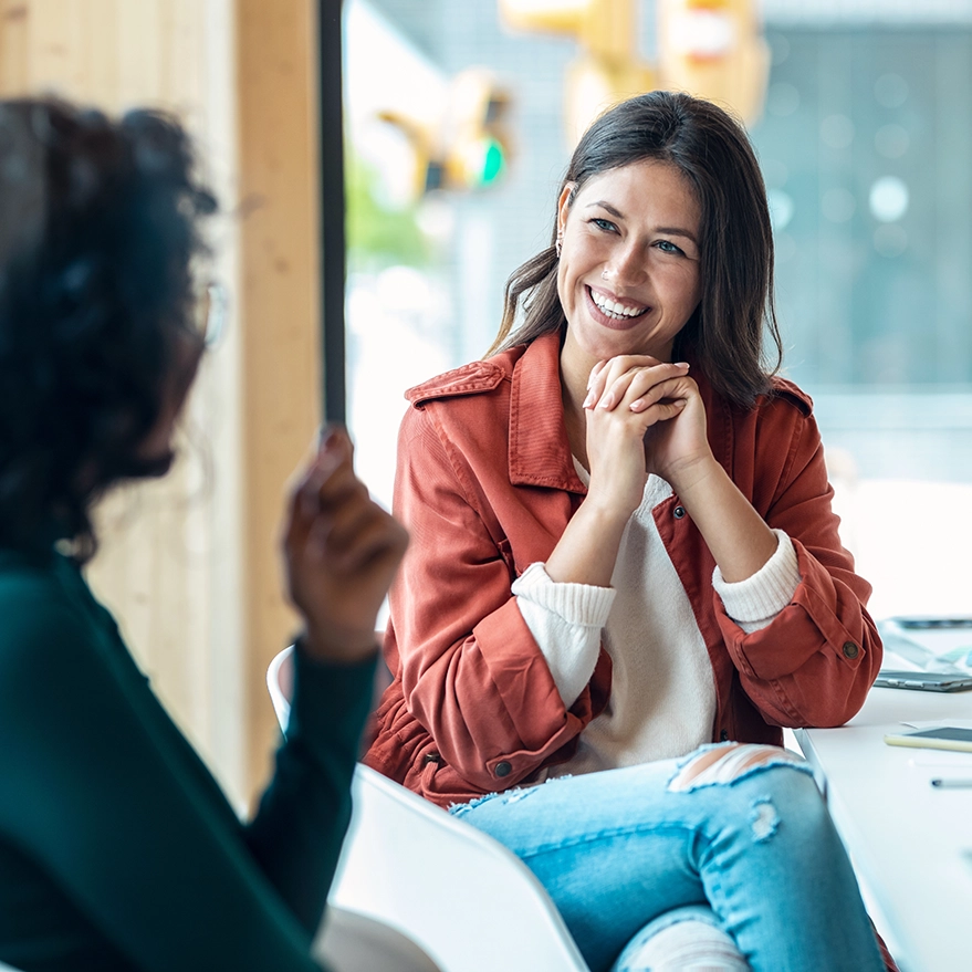 A businesswoman chats with a college.